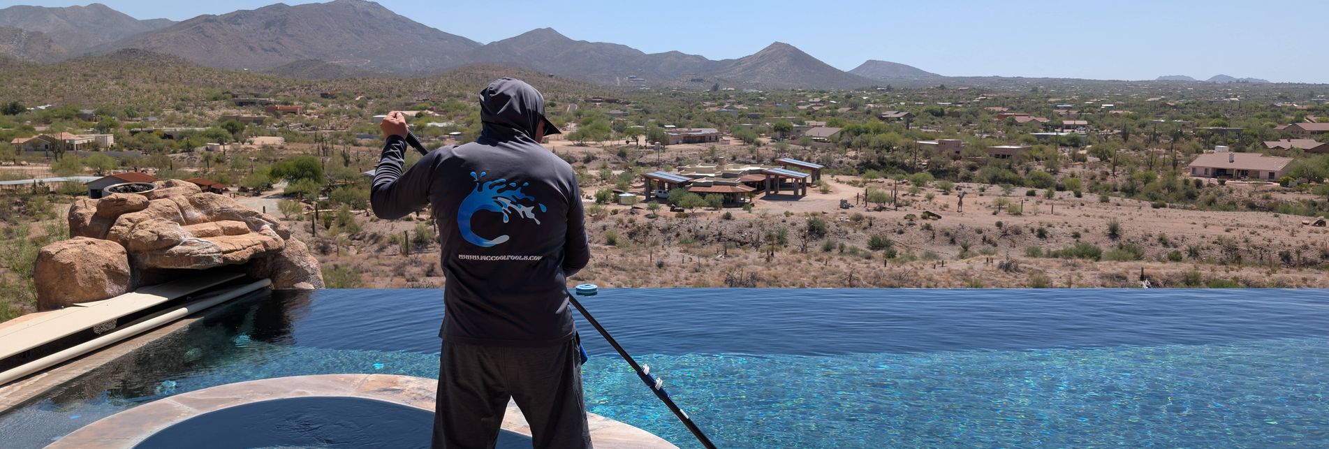 pool cleaner cleaning pool with scenic desert mountain view in Arizona