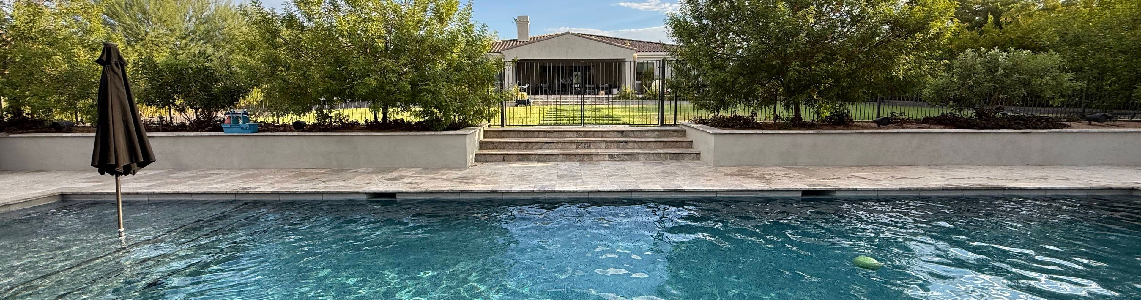 pool service technician maintaining crystal clear pool water