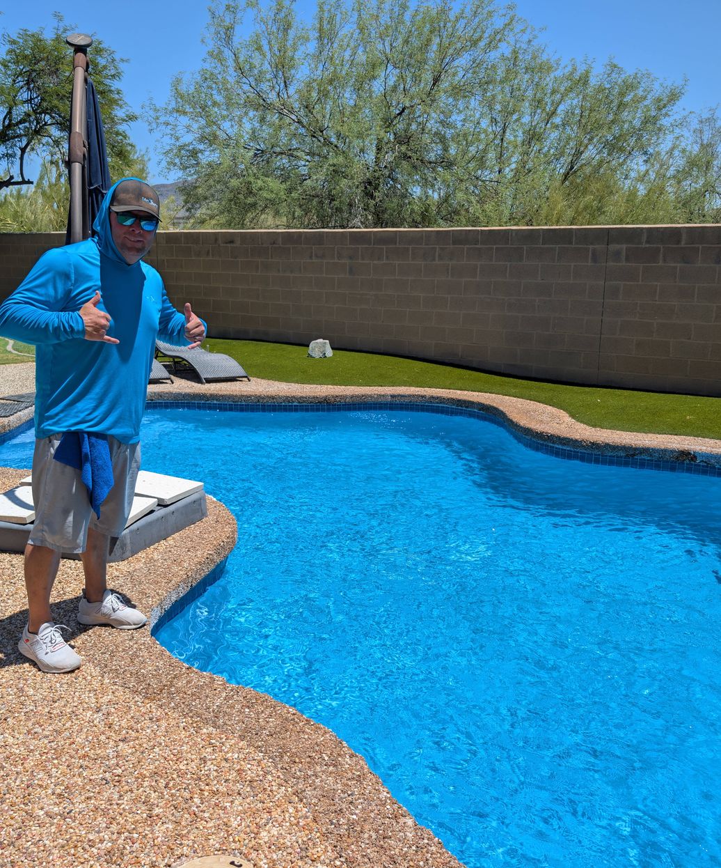 professional pool technician with pristine blue pool in Paradise Valley